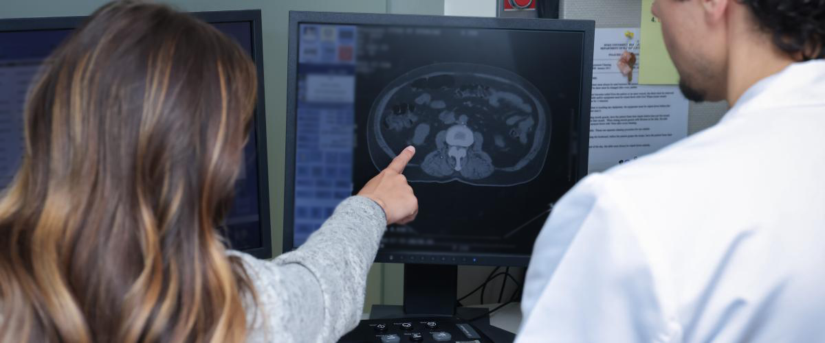 Radiation therapists pointing at scan