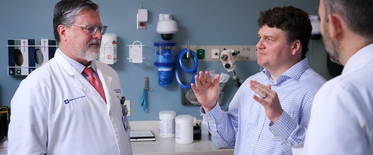 Drs. Floyd, Mullikin and Reitman talking in clinic