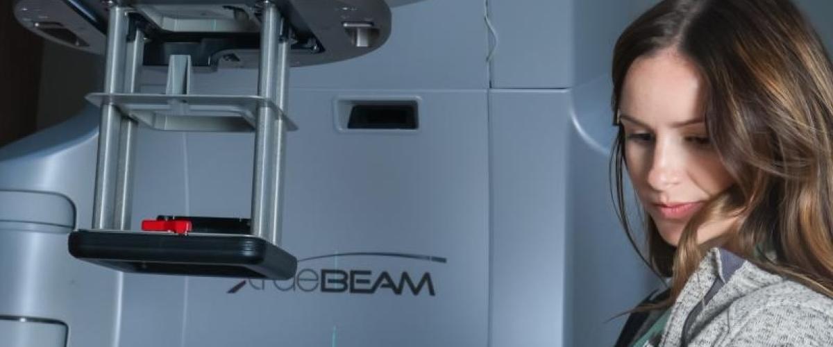 Radiation therapists adjusting technology